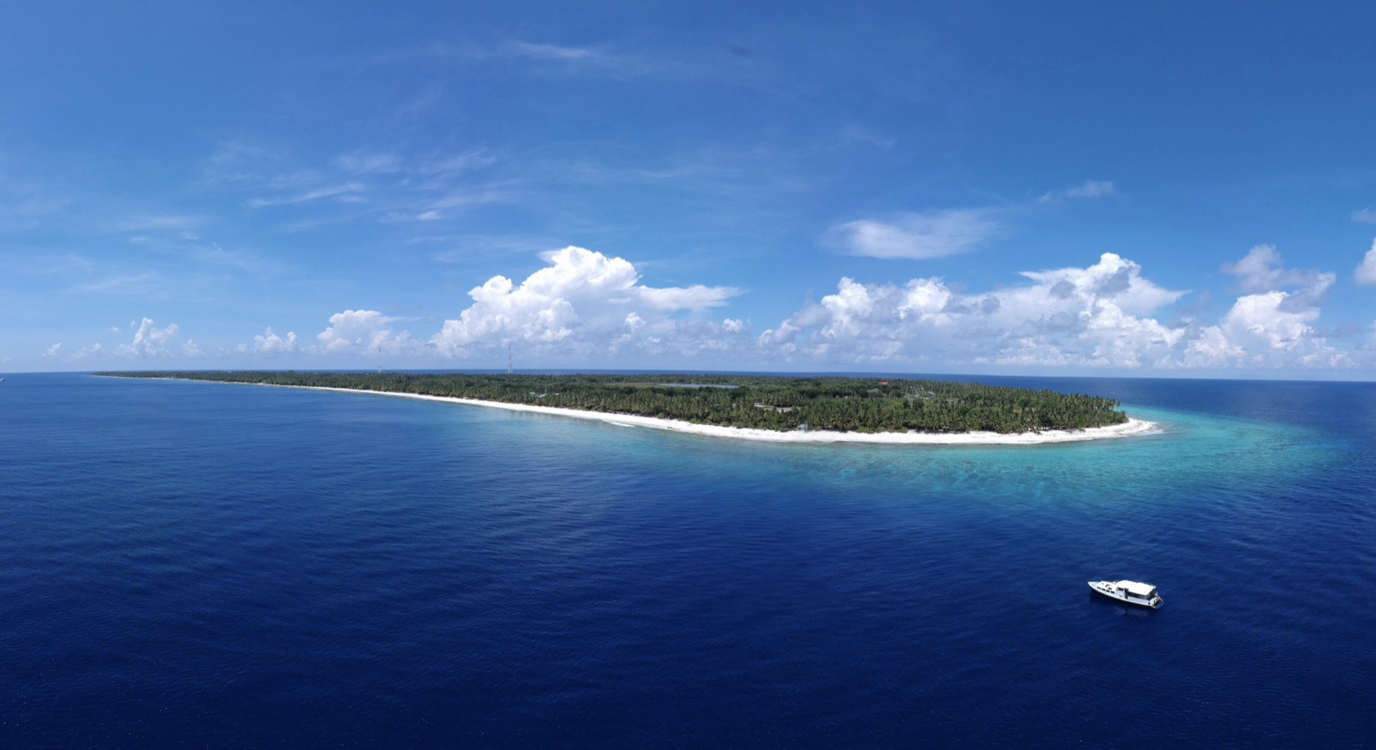 Aerial view of Fuvahmulah, a single narrow island with open ocean on both sides